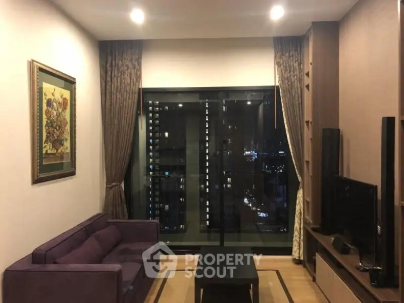 Elegant living room with city view, featuring a plush purple sofa and modern entertainment center.