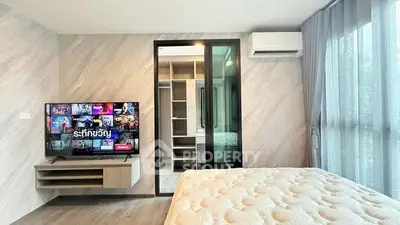 Modern bedroom with TV, air conditioning, and walk-in closet in stylish apartment.