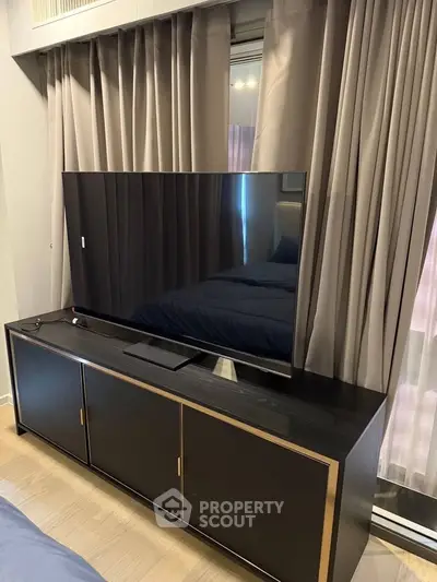 Modern living room with sleek TV stand and curtains