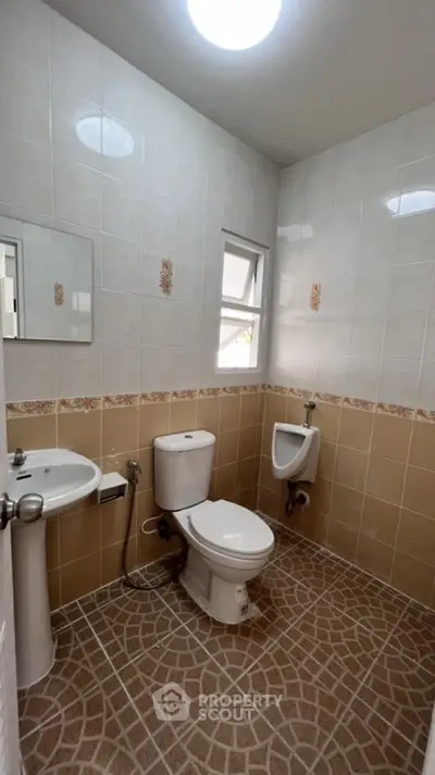 Spacious bathroom with modern fixtures and elegant tile design