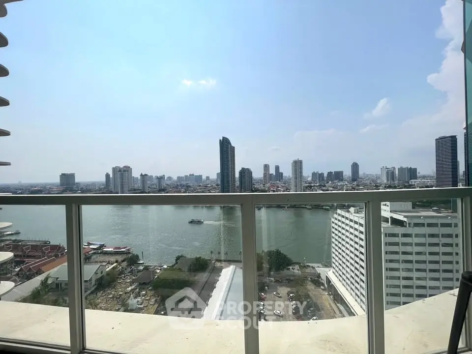 Stunning river view from high-rise balcony in urban skyline setting.