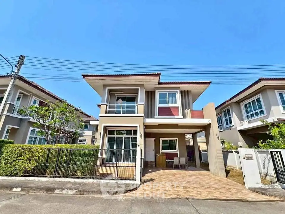 Modern two-story house with spacious driveway and lush greenery in a serene neighborhood.
