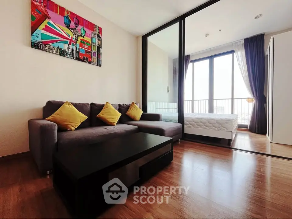 Modern living room with stylish decor and balcony view in a contemporary apartment.