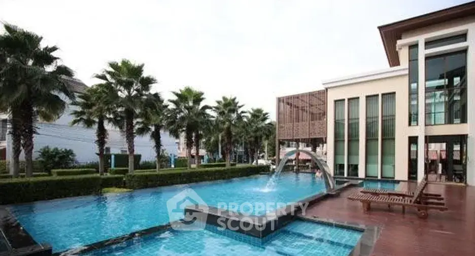 Luxurious residential complex with stunning pool and palm trees, perfect for relaxation and leisure.
