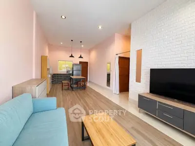 Spacious open-plan living room with modern decor and natural light
