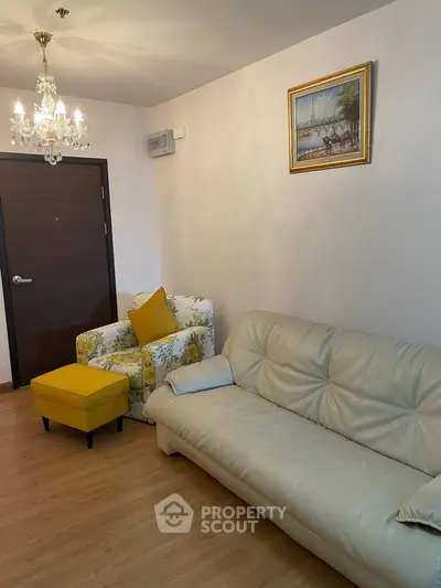 Cozy living room with elegant chandelier and stylish furniture, perfect for relaxation and entertaining.