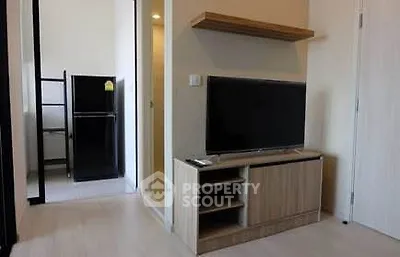 Modern living room with sleek TV stand and adjacent kitchen area