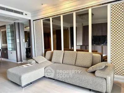 Spacious modern living room with stylish sofa and elegant decor, perfect for relaxation and entertainment.