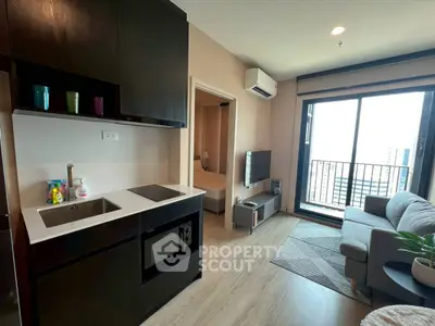 Modern apartment with open kitchen and cozy living room featuring city view balcony.