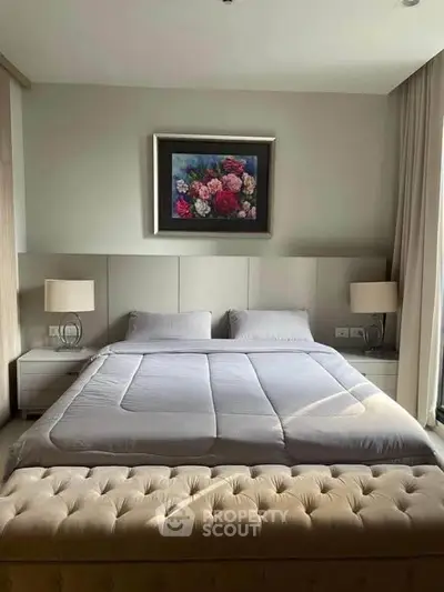 Luxurious bedroom with elegant decor and plush bedding in a modern apartment.