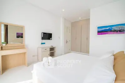 Bright and airy bedroom with modern furnishings and ample storage space.