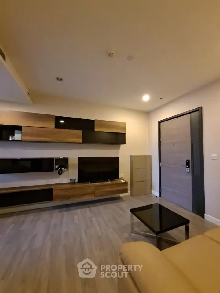 Modern living room with stylish wooden furniture and sleek design.