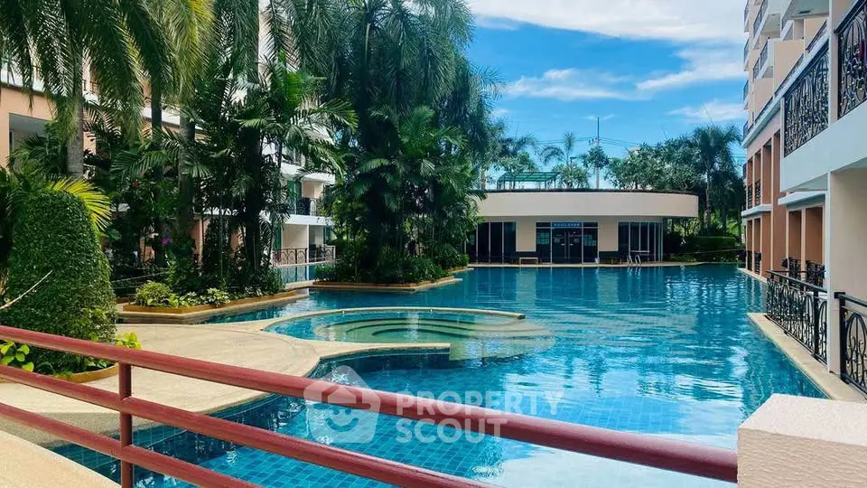 Luxurious residential pool area with lush greenery and modern architecture.