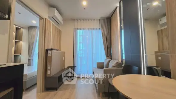 Modern living room with stylish decor and natural light in a contemporary apartment.