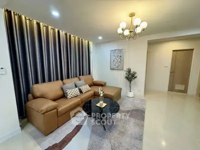Elegant living room with modern chandelier and cozy brown sofa in stylish apartment.