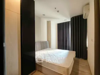 Modern bedroom with sleek design and natural light, featuring a comfortable bed and stylish decor.