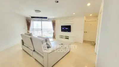 Spacious modern living room with large windows and sleek furniture