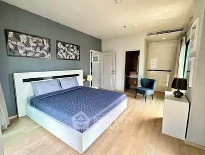 Spacious modern bedroom with stylish decor and natural light