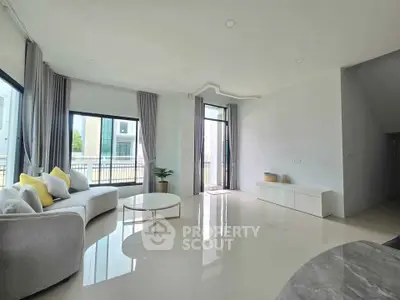 Spacious modern living room with large windows and elegant decor