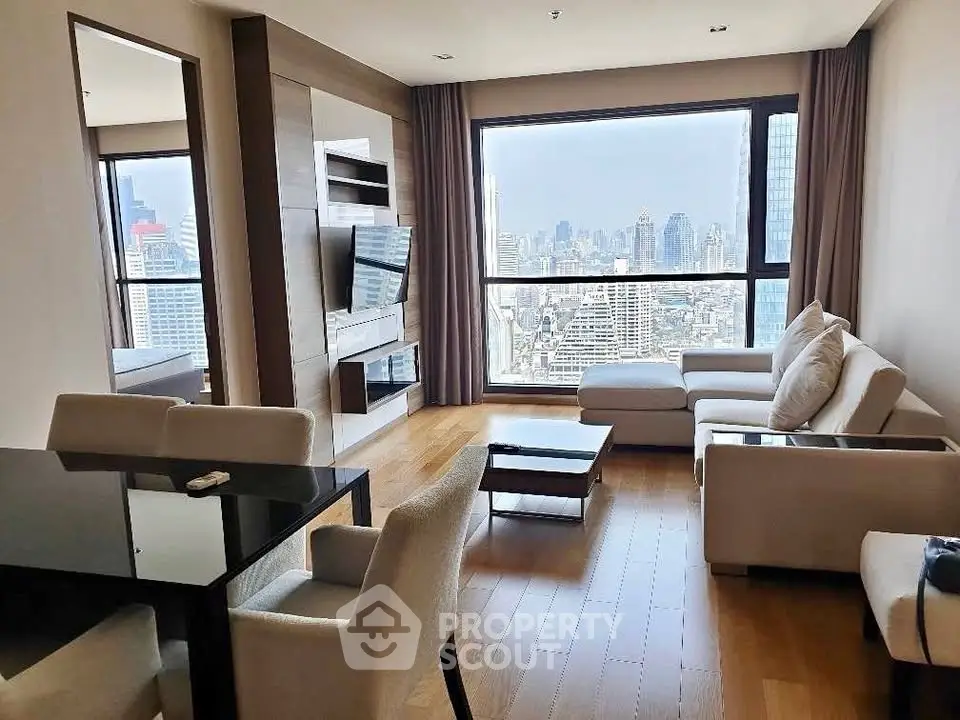 Luxurious living room with stunning city view, modern furniture, and elegant decor in high-rise apartment.