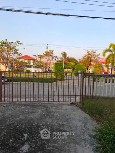Charming suburban neighborhood view with lush greenery and gated entrance