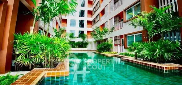 Luxurious apartment complex with stunning pool and lush greenery