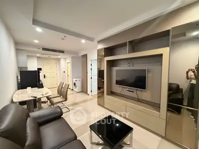 Modern living room with sleek furniture and built-in TV unit in a stylish apartment.