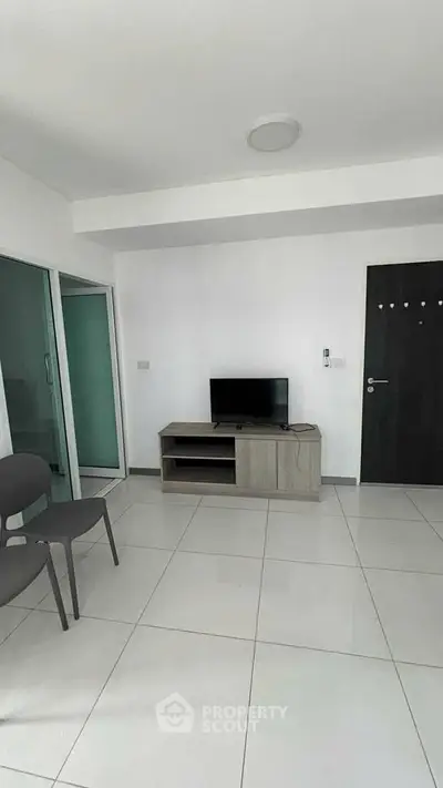 Modern minimalist living room with sleek furniture and tiled flooring