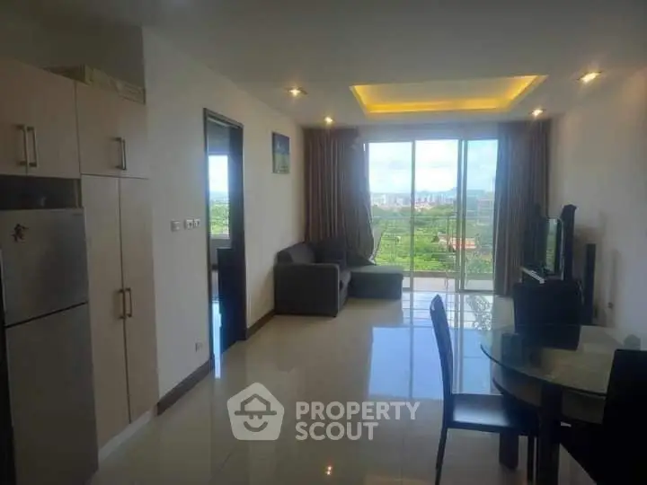 Modern living room with large windows and scenic view, open layout with dining area and kitchen.