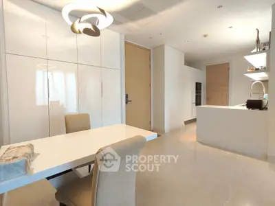 Modern kitchen and dining area with sleek design and ample natural light.