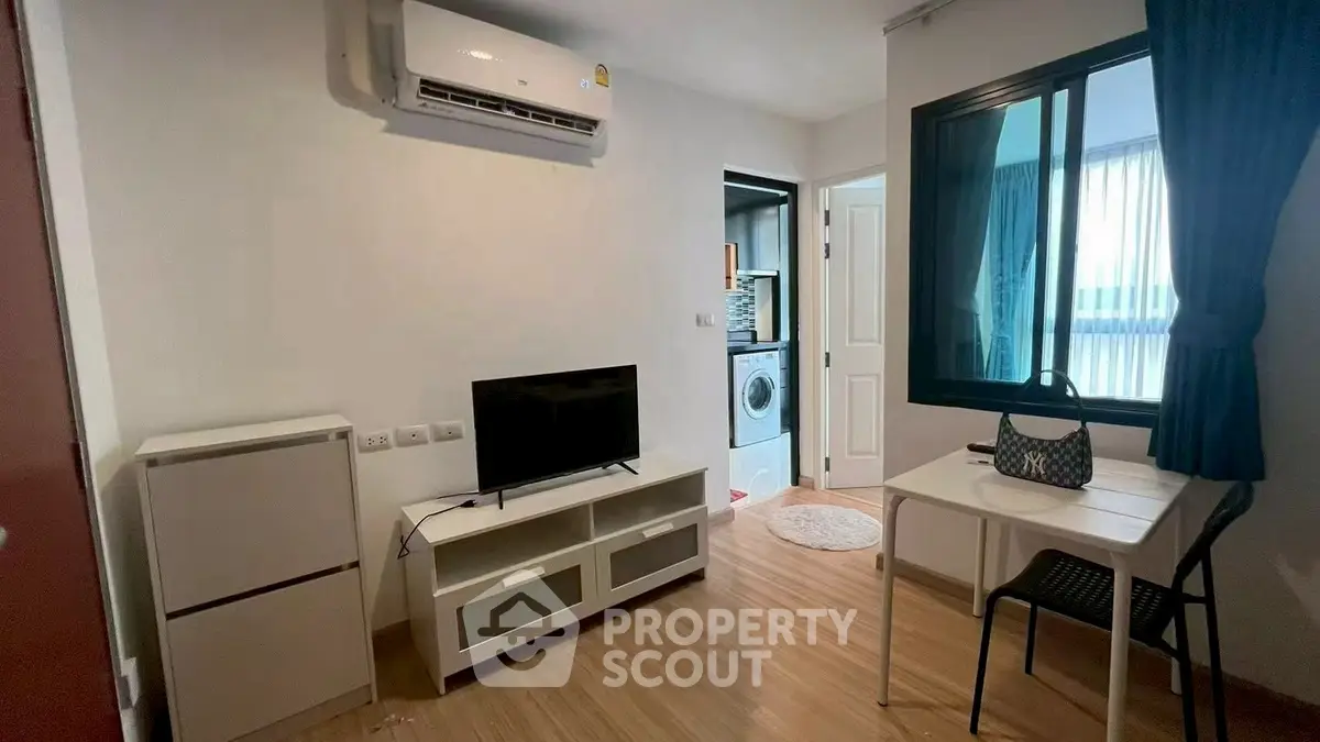 Modern apartment with compact living area and in-unit laundry