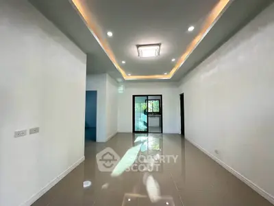 Spacious modern living room with sleek lighting and glossy floors