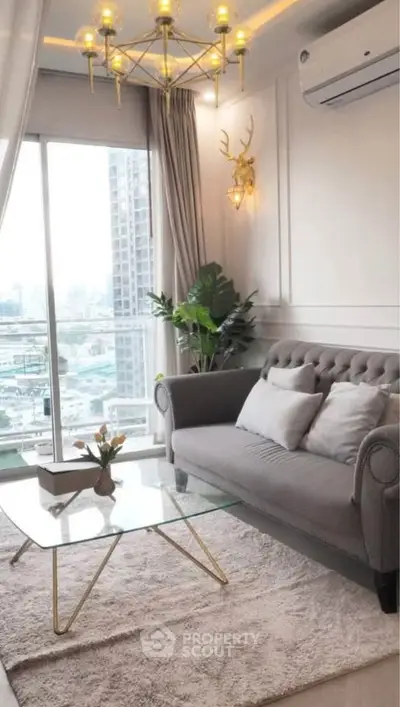 Stylish living room with elegant decor and city view, featuring a plush sofa and modern chandelier.
