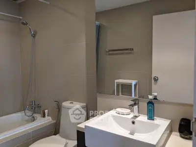 Modern bathroom with sleek fixtures and bathtub in contemporary apartment.