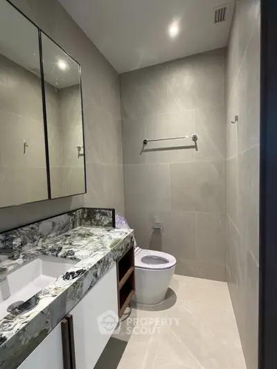 Luxurious modern bathroom with elegant marble countertop and sleek design.