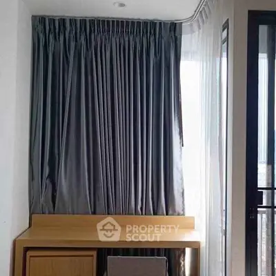 Modern bedroom with elegant curtains and sleek furniture design.