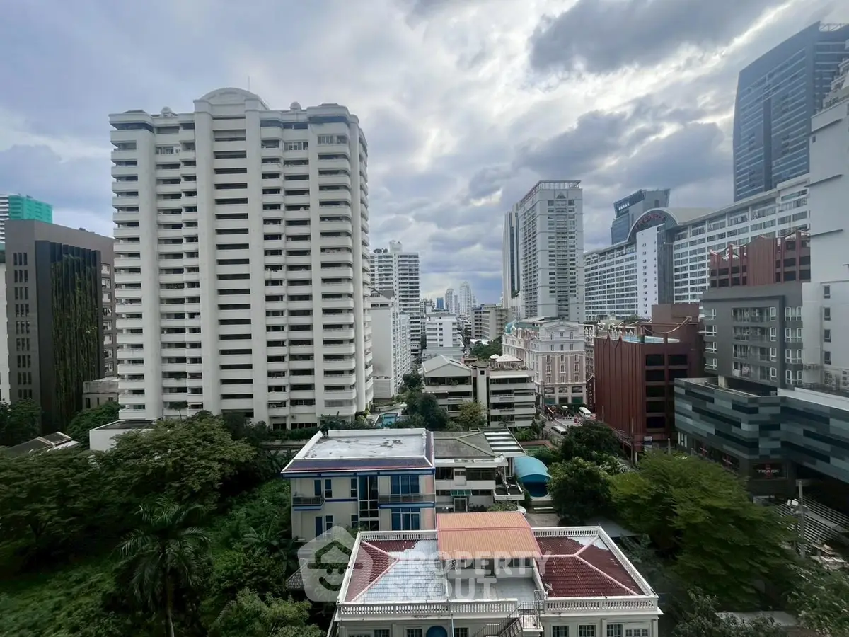 Stunning cityscape view showcasing modern high-rise buildings and lush greenery.