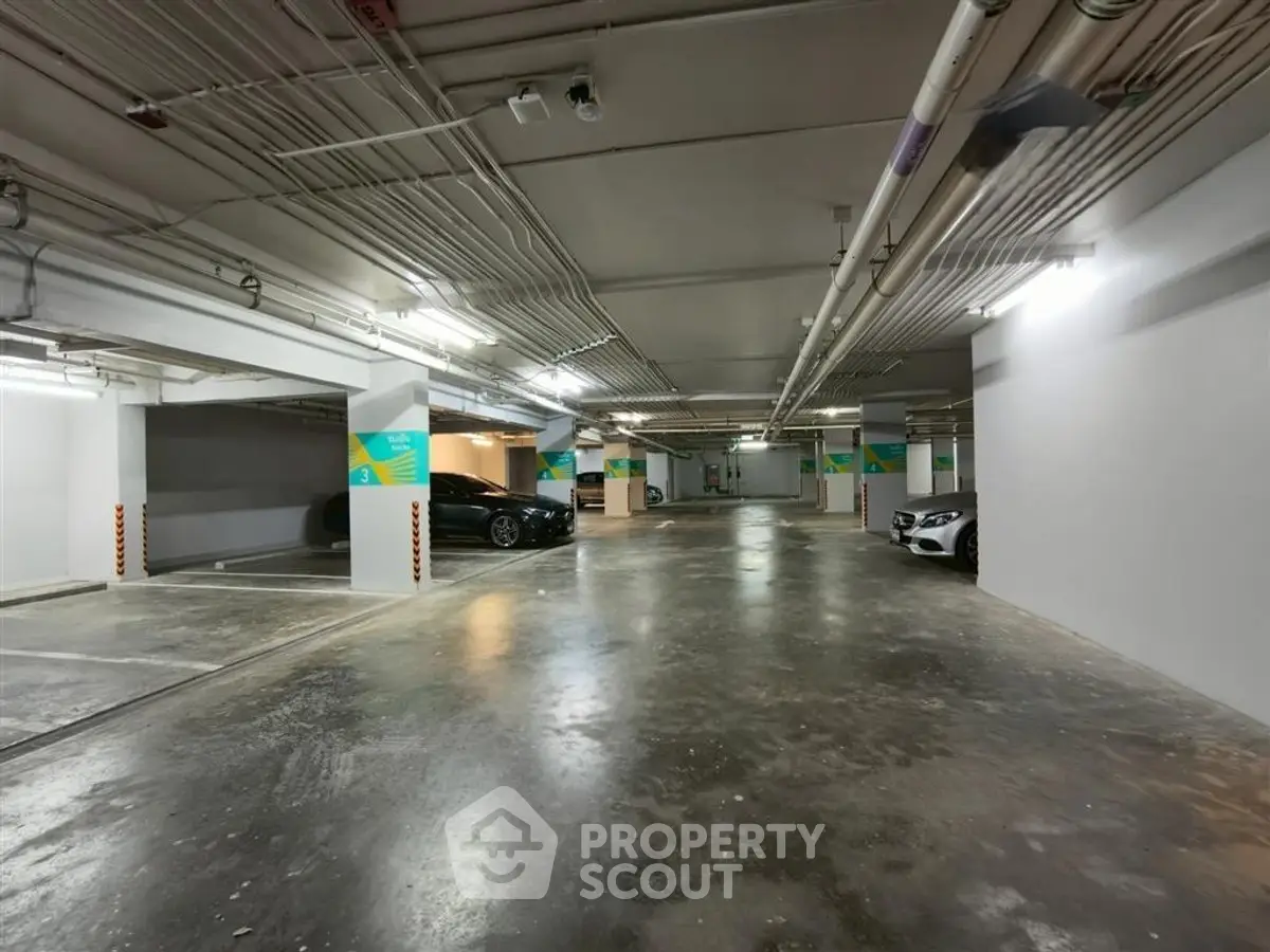 Spacious underground parking garage with ample lighting and multiple parking spaces.