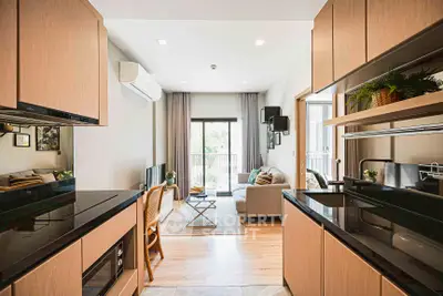 Modern open-layout kitchen and living room with sleek design and natural light.