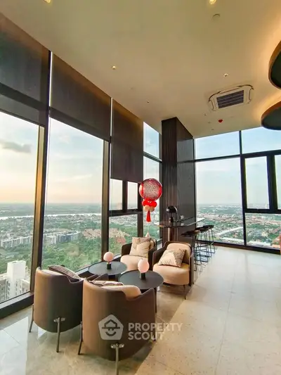 Luxurious high-rise living room with panoramic city views and elegant modern decor.