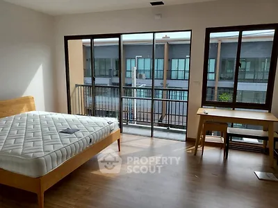 Spacious bedroom with balcony and natural light in modern apartment