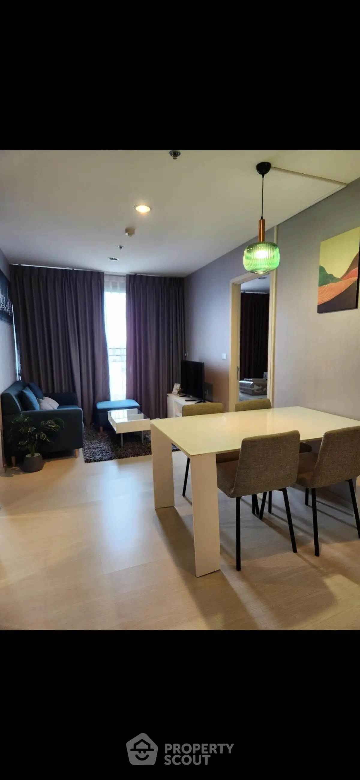 Modern living room with stylish decor and natural light, perfect for relaxation and entertainment.