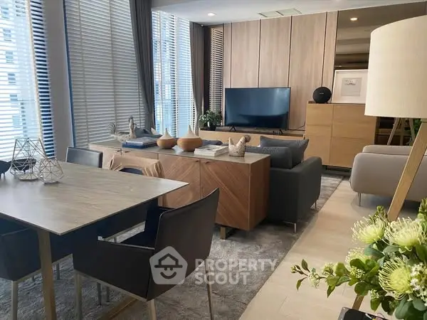 Modern living room with stylish decor and large windows in a luxury apartment.