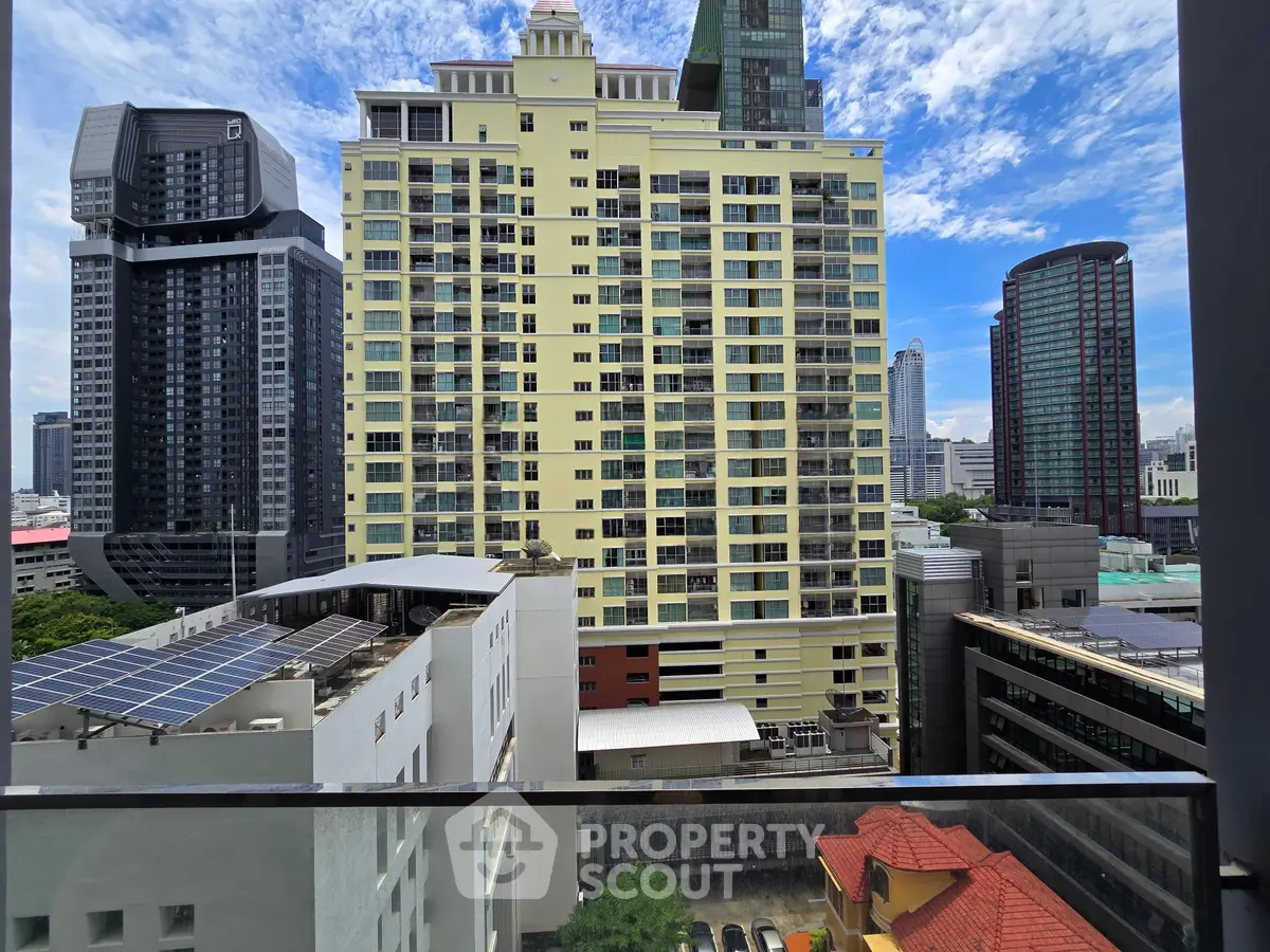 Stunning cityscape view from a high-rise balcony showcasing modern architecture and vibrant skyline.
