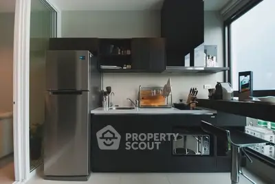 Modern kitchen with sleek appliances and open layout in urban apartment.