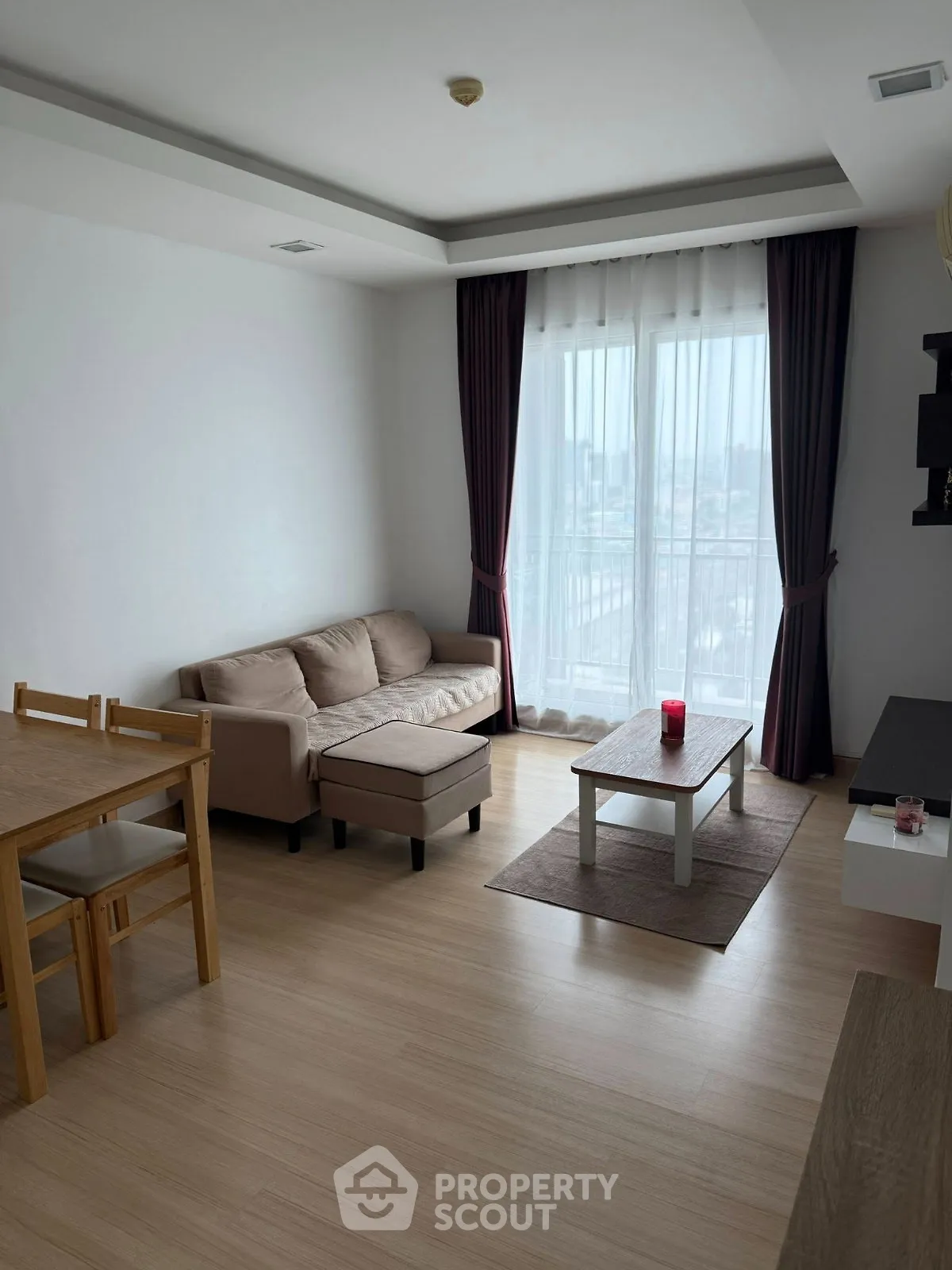 Modern living room with natural light and cozy furniture in a stylish apartment.