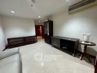 Spacious living room with modern furniture and tiled flooring