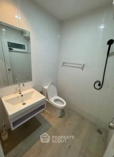 Modern bathroom with sleek fixtures and white tile design