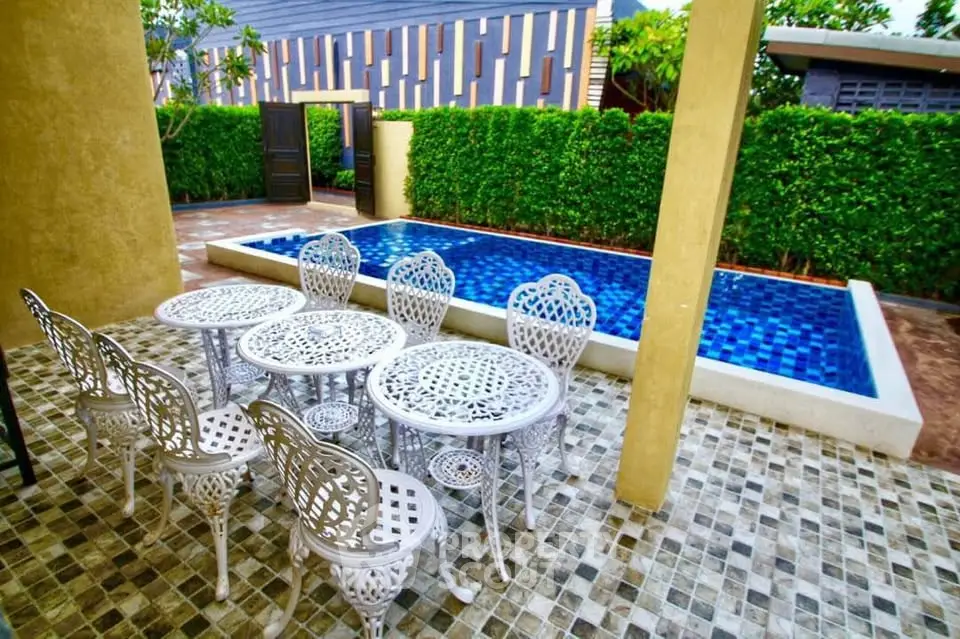 Charming outdoor patio with elegant seating and private pool, perfect for relaxation and entertaining.