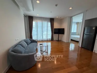 Spacious modern living room with hardwood floors and natural light
